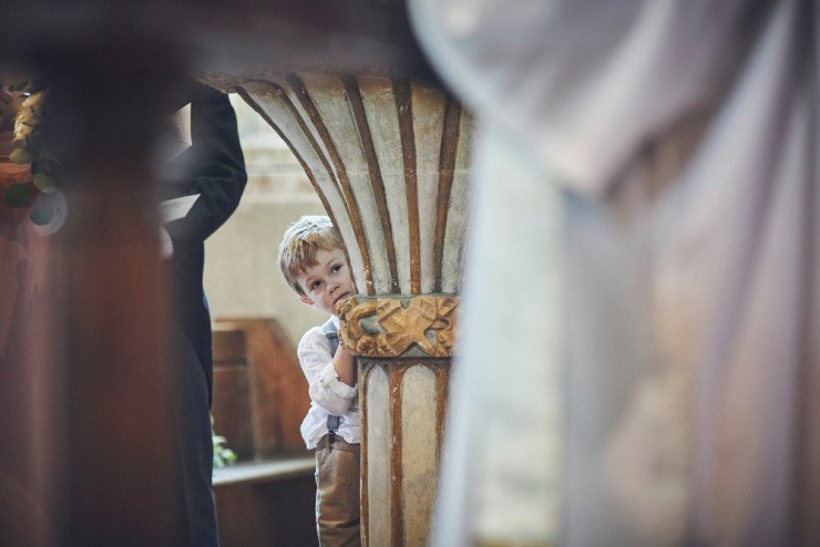 documentary wedding photography of little boy peeping at bride and groom south hams wedding in devon