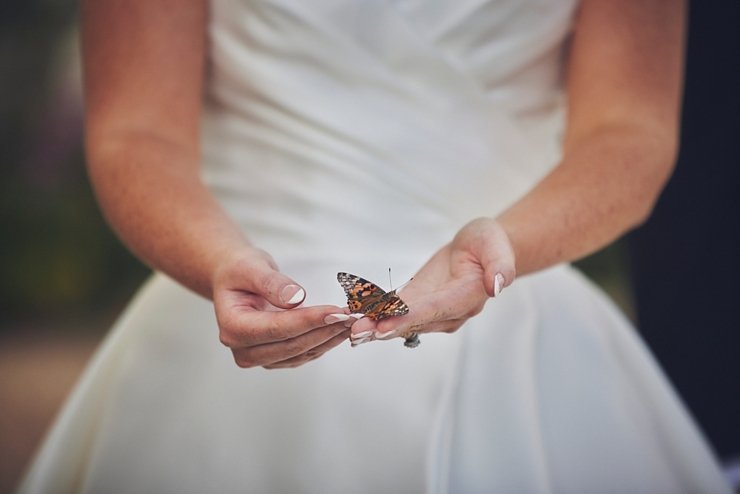 bride holding butterfly at Rockbeare Manor in Exeter