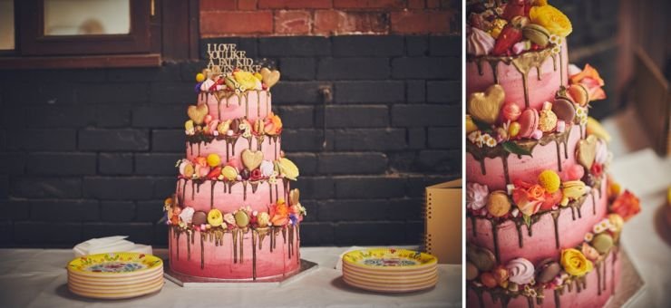 colourful cake covered in chocolates and macaroons at West Town Farm barn wedding