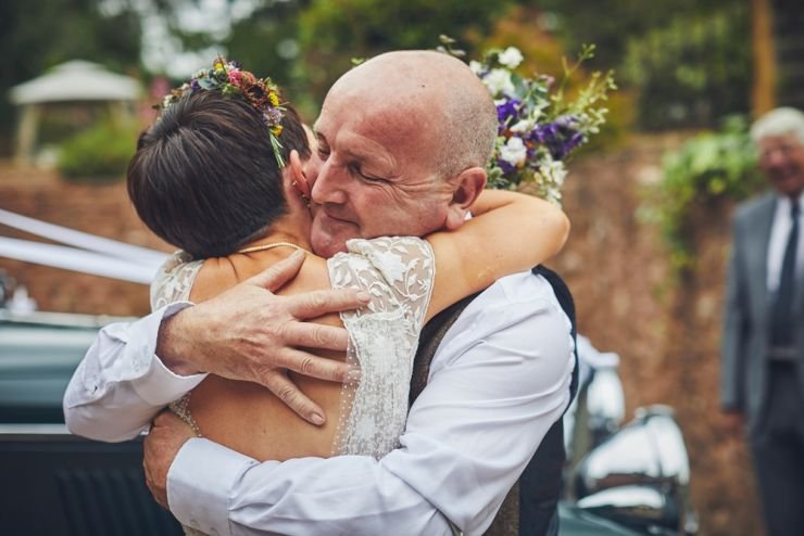 father and daughter embrace before her wedding 