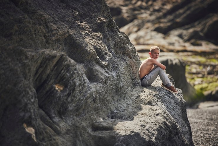 child on rocks at tunnels beaches in Devon