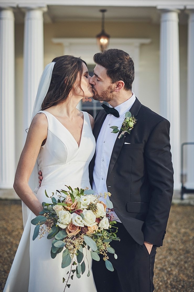 relaxed wedding photography of bride and groom kissing at mini wedding in Devon
