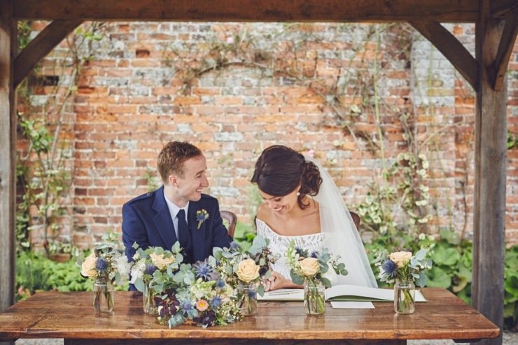 candid wedding photography of signing the register Kingston Estate Devon