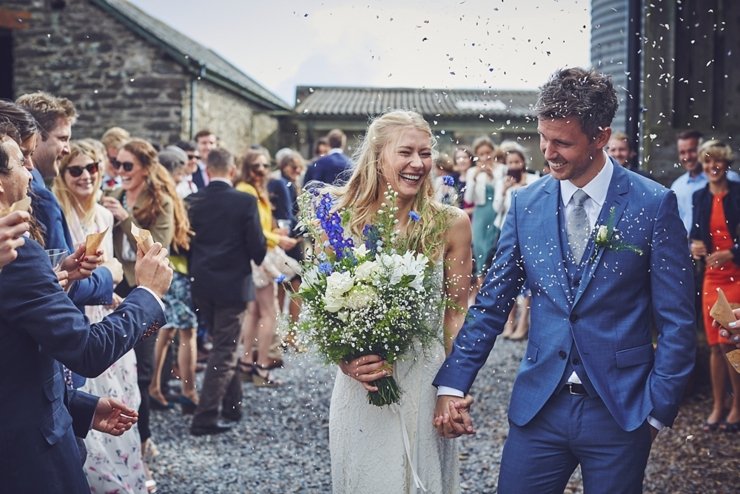 guests holding hands at humanist ceremony at East Soar in Devon
