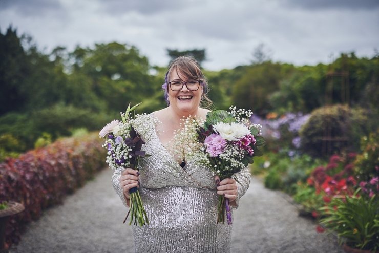 bridesmaids in silver sequinned dress smiling at Pentille castle Cornwall