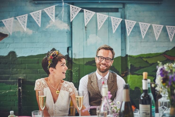 reportage wedding photography of bride and groom's reaction to speeches at a wedding at a West Town Farm devon