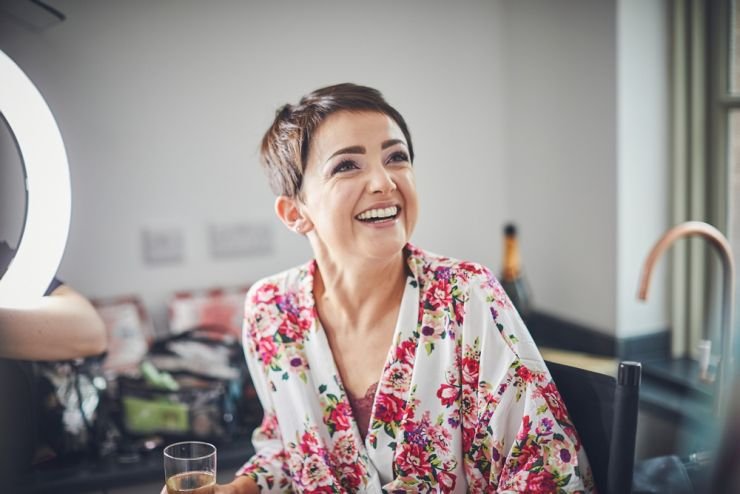 bride to be laughing, looking up, wearing robe