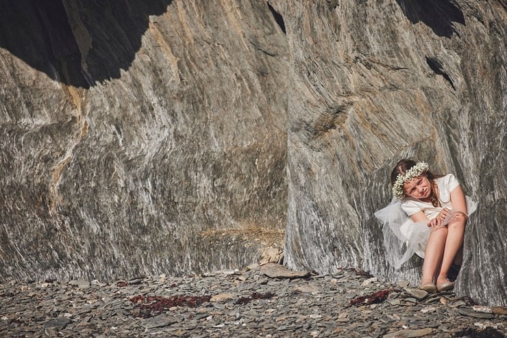 flower girl sitting on rocks at tunnels beaches ilfracombe