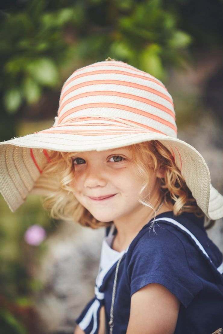 photography of child smiling at camera at a diy barn wedding at West Town Farm in devon