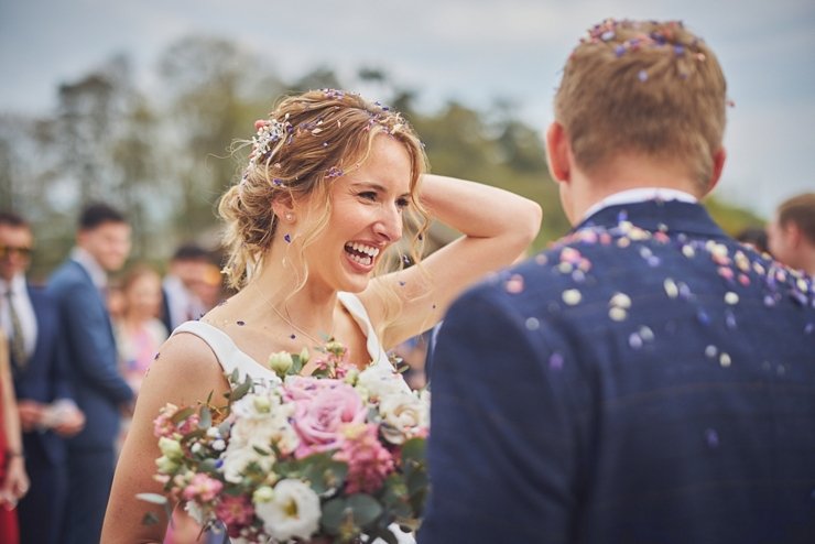bride laughing after confetti toss at Upton Barn and walled garden 