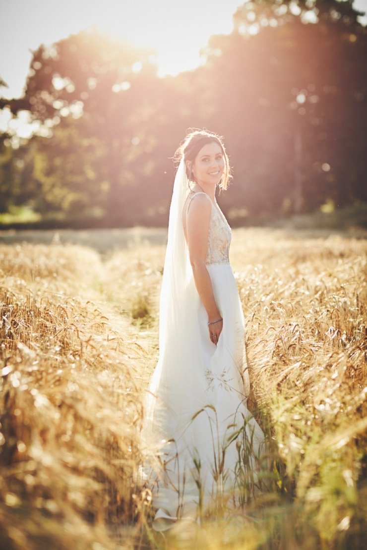 couple in the cornfield at summer wedding in Devon wedding venue upton barn