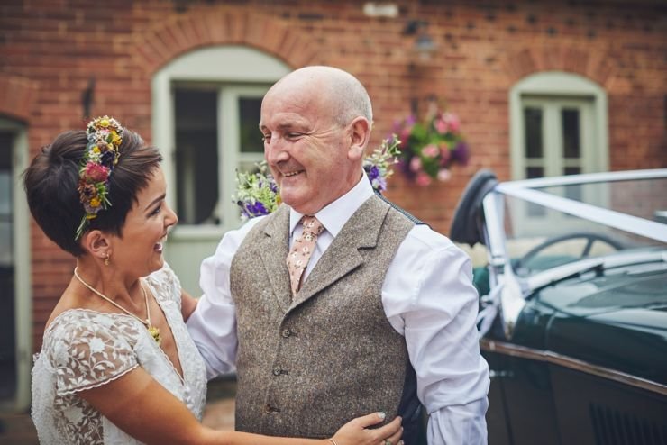 father of bride smiling at his daughter 
