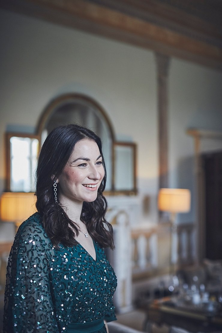bridesmaid smiling in green sequinned dress at mini wedding at Rockbeare manor Devon