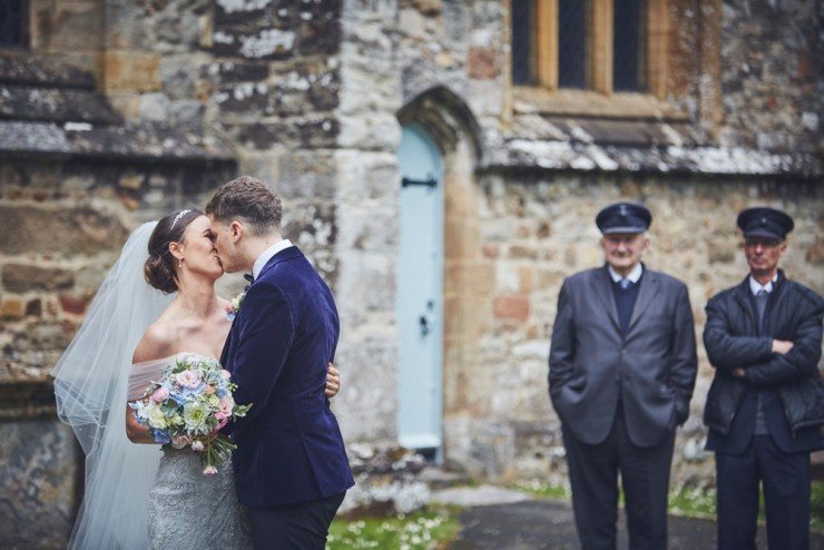 bride and groom kissing, fun photography of a wedding at upton barn devon