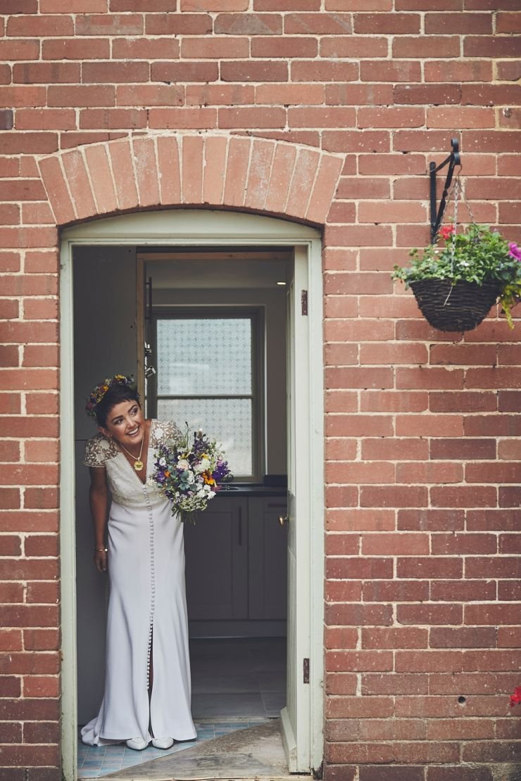bride in doorway peering out