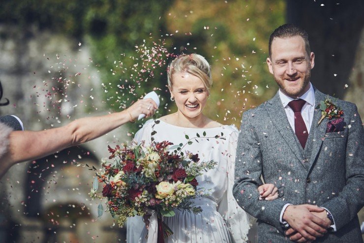 Devon team of two wedding photographers capture confetti throw at an Autumn wedding in the barn at Hotel Endsleigh in Devon