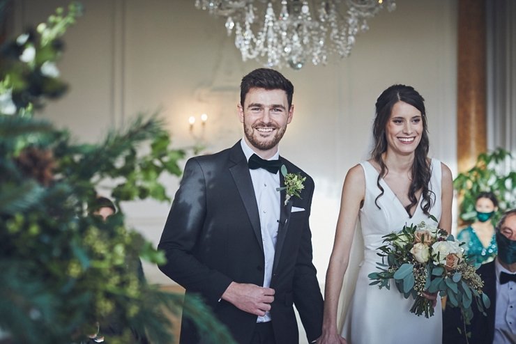 groom wearing black tie and smiling at small wedding at Rockbeare manor in Devon