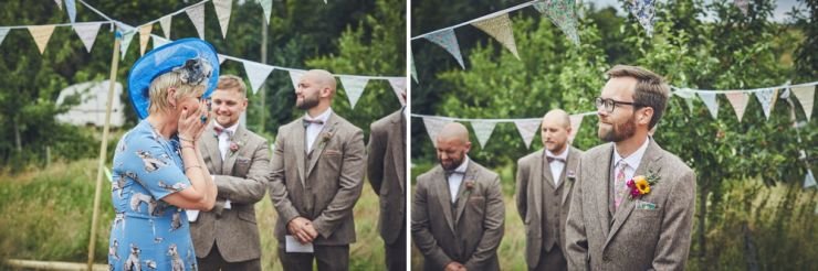 Groom and mother of bride watching for bride to make entrance at West Town Farm in Devon