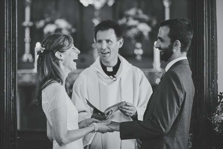 reportage photography of couple laughing during ceremony at South Hams wedding