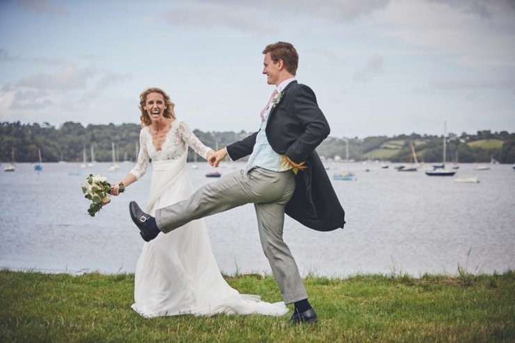 bride and groom laughing at marquee wedding Devon
