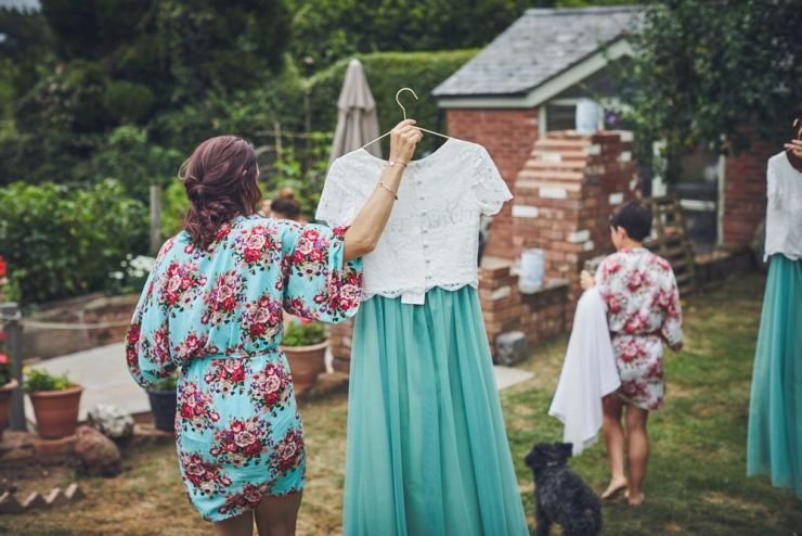 bridesmaid carrying her bridesmaids separates with a white top and green skirt