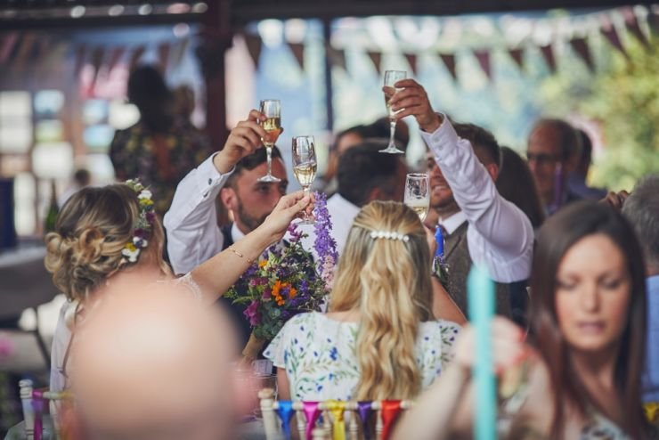 reportage wedding photography of guests at speeches at a wedding at a West Town Farm devon