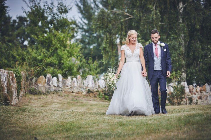 bride and groom walking happily at Somerset wedding