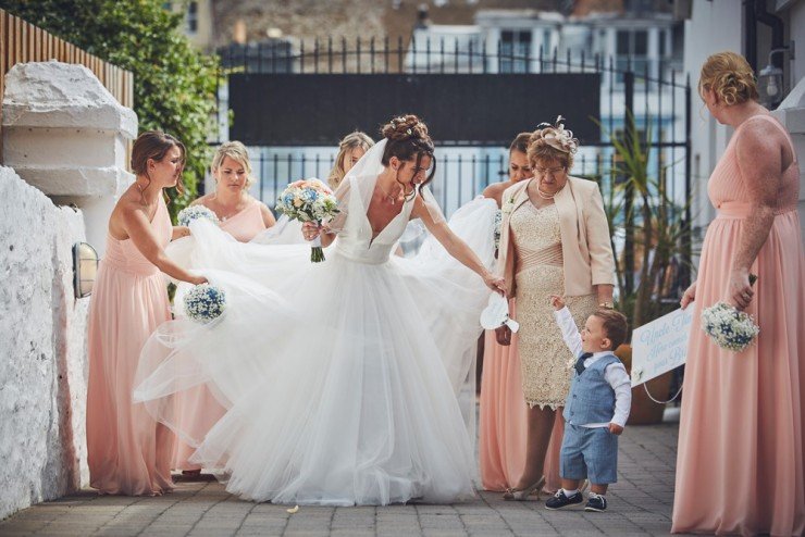 bridal party walking to ceremony at beach wedding at tunnels beaches in devon