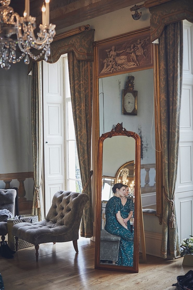 bridesmaids in reflection of an old mirror at a small wedding at Rockbeare Manor in Exeter