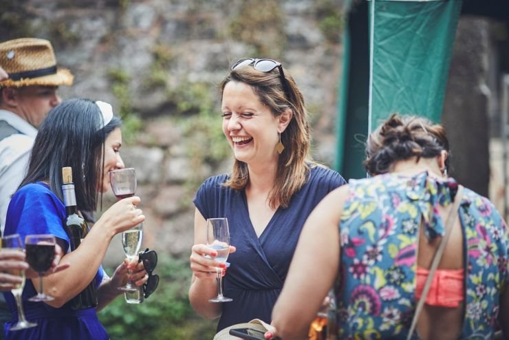 relaxed wedding photography of guests laughing at a wedding at a West Town Farm devon