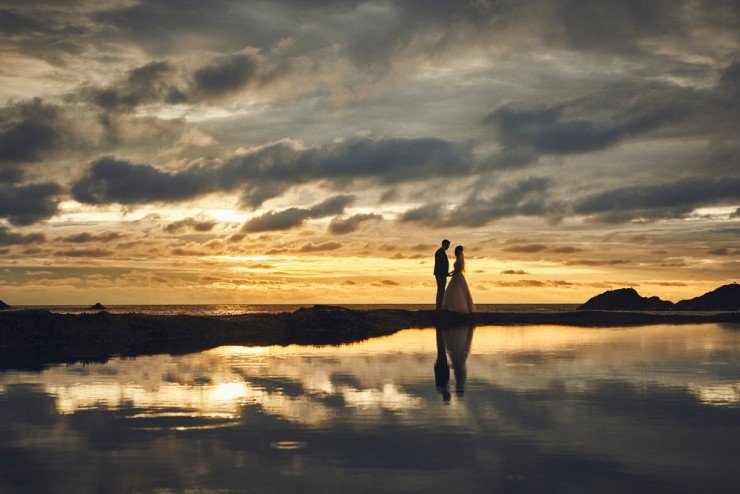 bride and groom portrait taken at sunset at tunnels beaches in devon