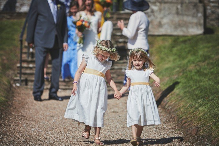 flower girls running into church at South Hams wedding in devon