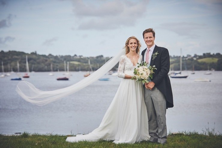 bride and groom laughing at marquee wedding Devon