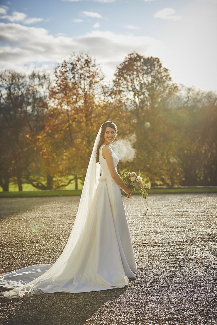 portrait of happy bride at small winter wedding at Rockbeare manor in Devon