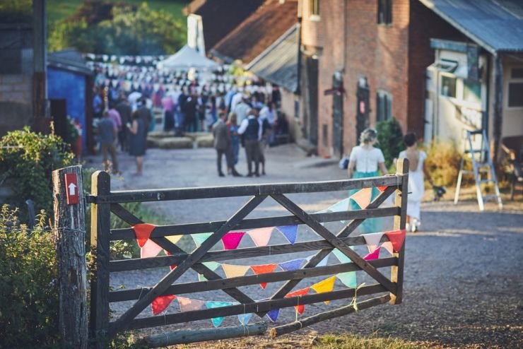 golden hour photography of wedding venue with gate and bunting at West Town Farm exeter
