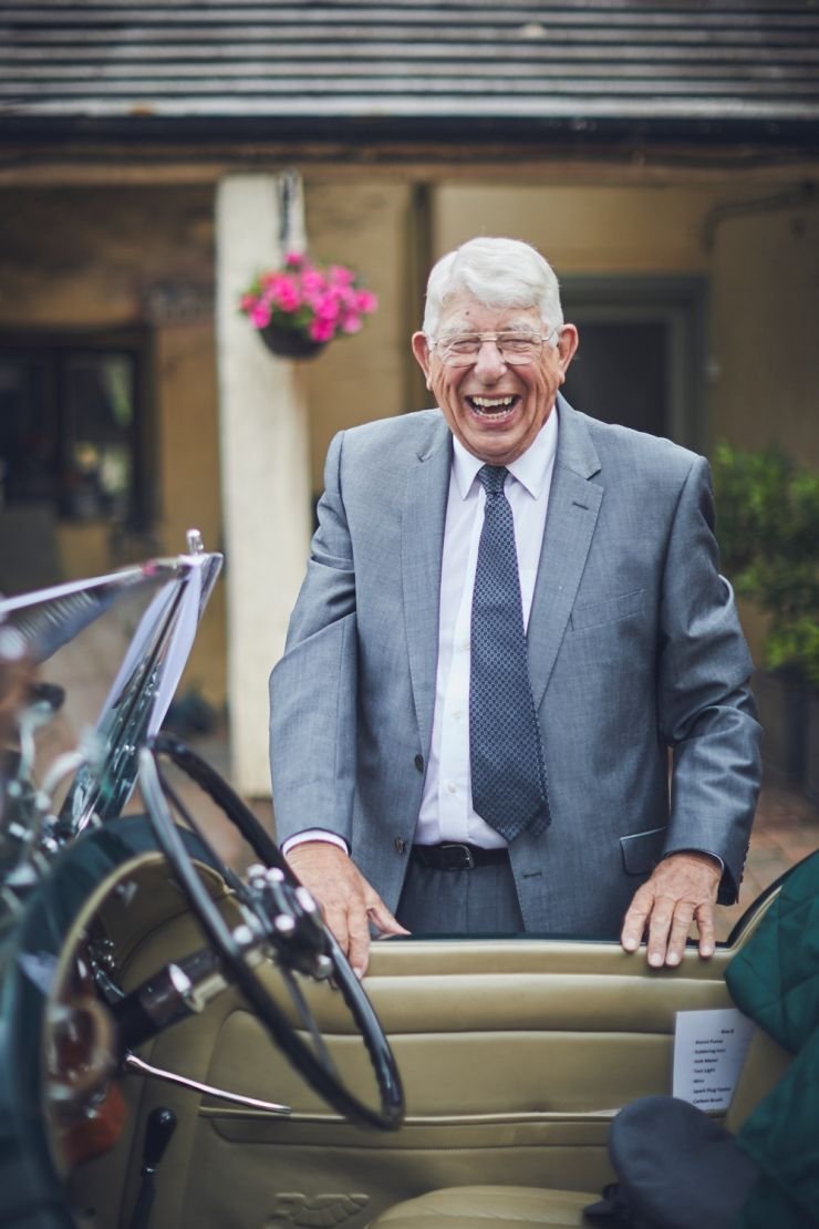 brides Grandad laughing as he realises he's having his photo taken