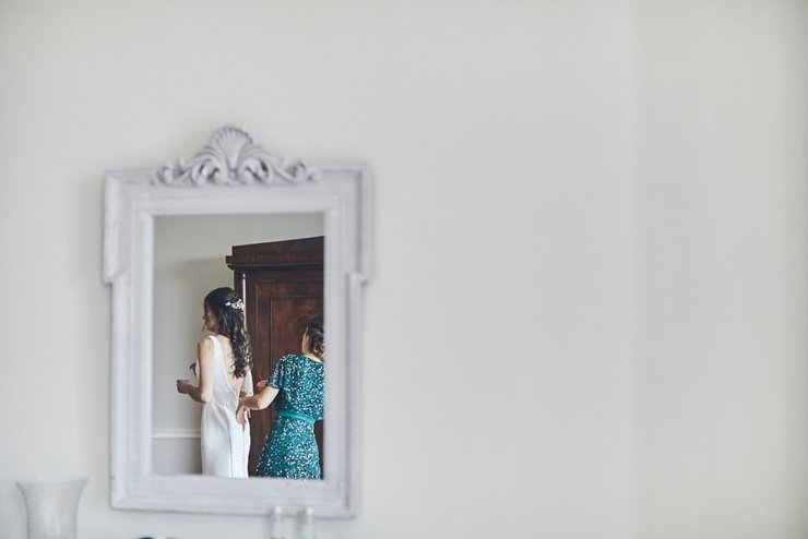 bride and maid of honour in mirror at a mini wedding at Rockbeare manor Devon