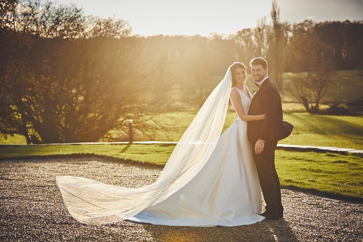 bride and groom in golden hour sunlight at small winter wedding at Rockbeare manor in Devon