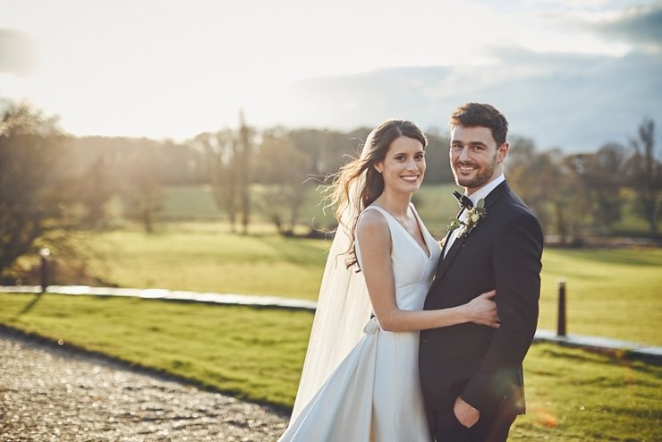 bride and groom in golden hour sunlight at small winter wedding at Rockbeare manor in Devon