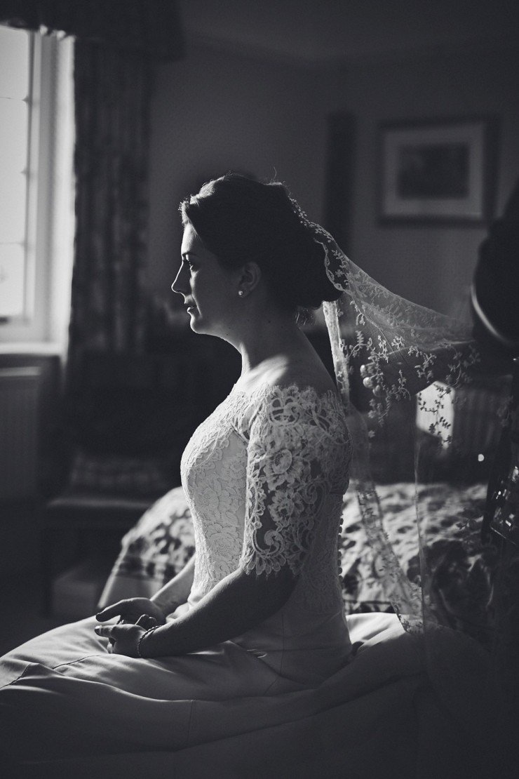 black and white wedding photography of Devon bride seated with veil