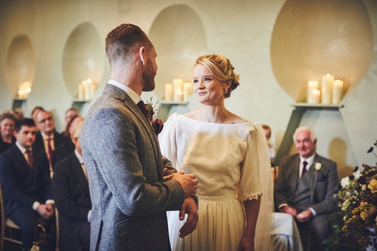 relaxed wedding photography of an Autumn wedding ceremony in the barn at Hotel Endsleigh in Devon