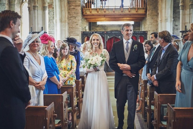 bride walking down the aisle with dad at Devon church wedding