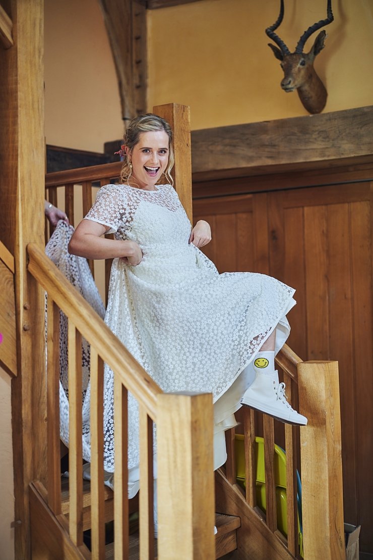 Bride wearing smiley socks and wedding converse at Devon wedding
