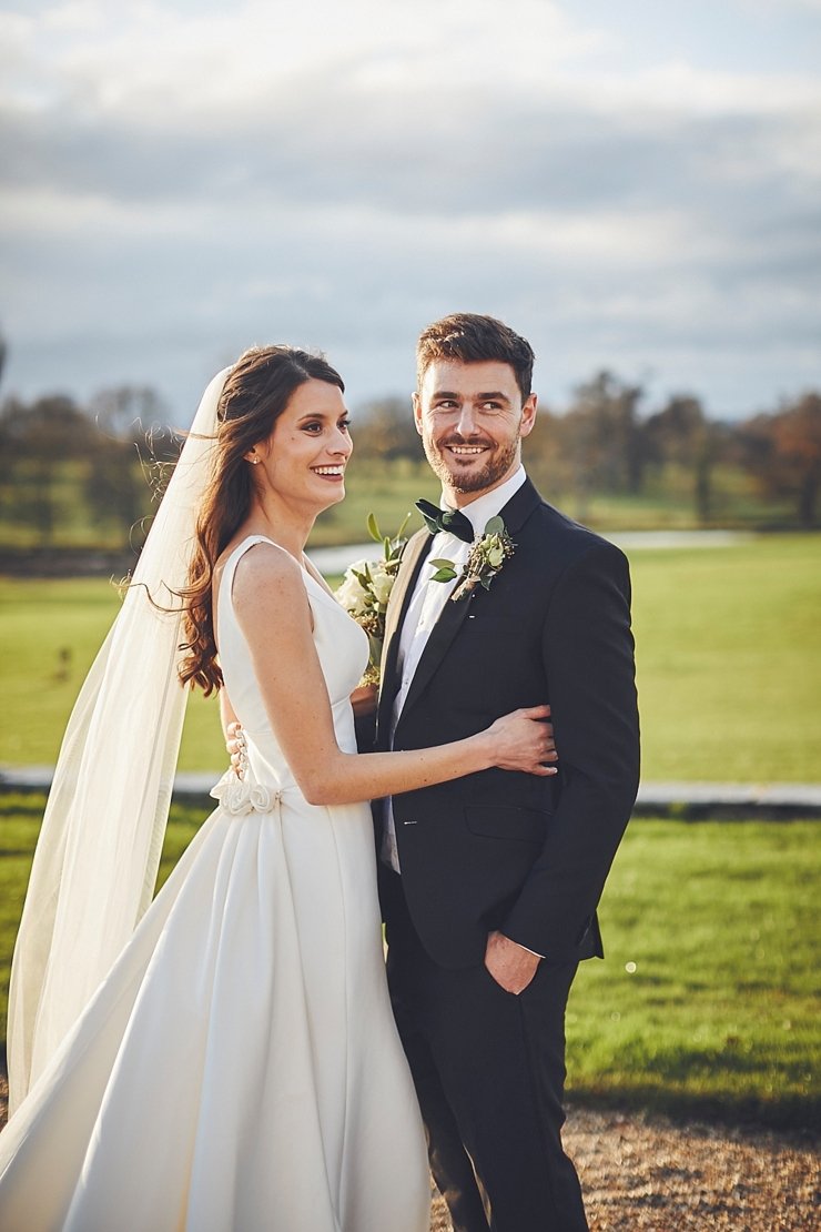 bride and groom in golden hour sunlight at small winter wedding at Rockbeare manor in Devon