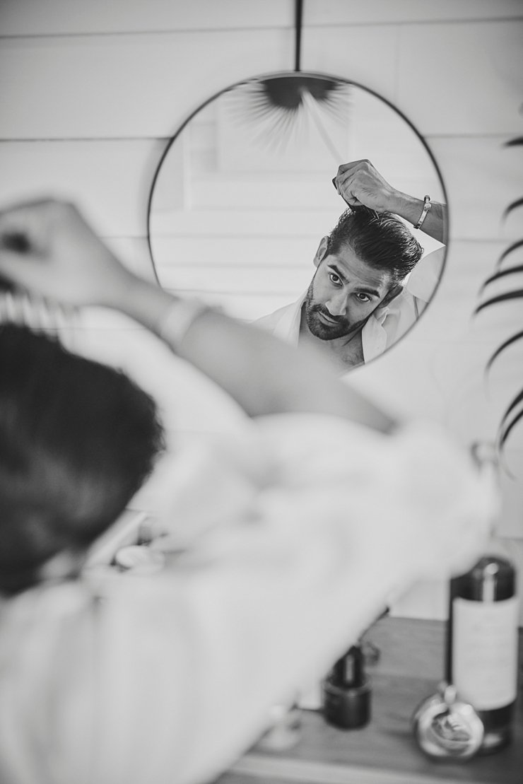 groom gets ready in mirror tunnels beaches