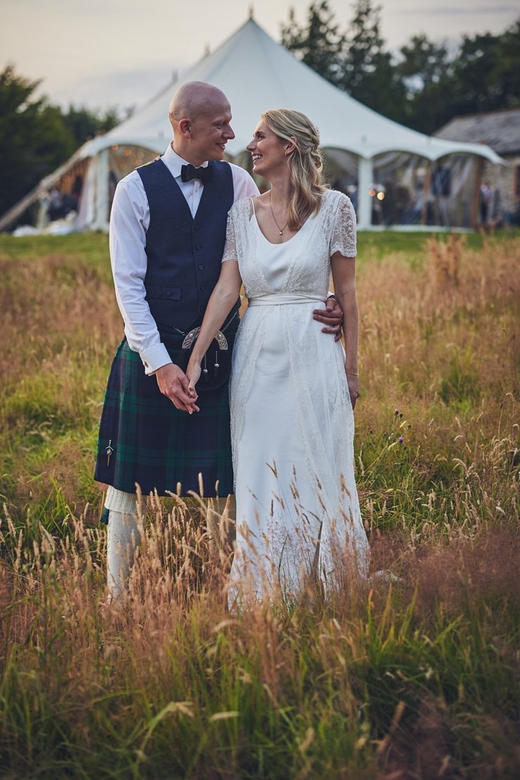 groom in kilt with bride at vintage marquee wedding in devon