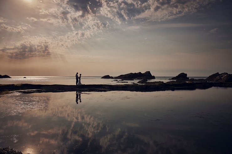 couple on tidal wall at tunnels beaches
