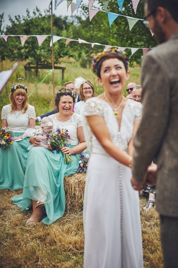 wedding photography of bride laughing during ceremony at West Town Farm in Devon
