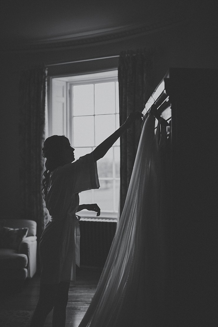 bride reaching for her wedding dress at her micro wedding in Devon