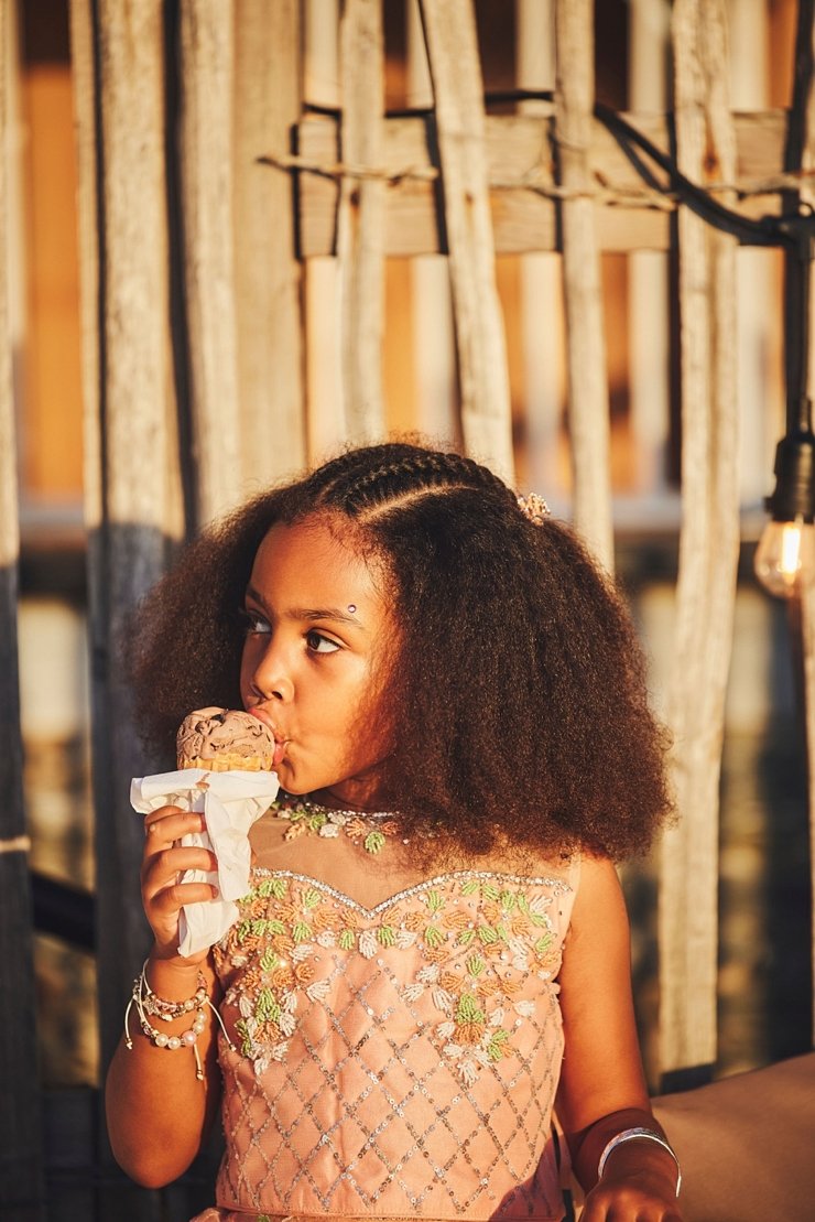 little girl licking ice cream at sunset at tunnels beaches Devon